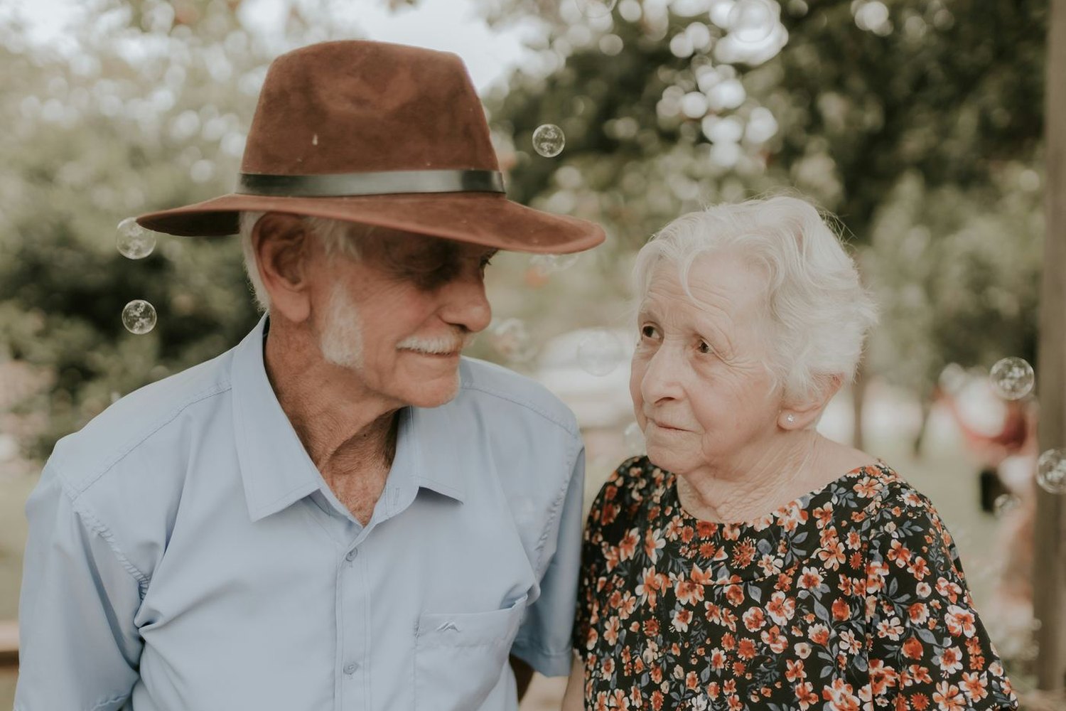 An older couple outdoors together on a bright afternoon